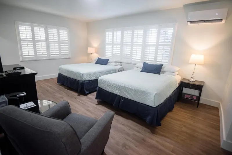 Double Queen room with both beds and a dresser